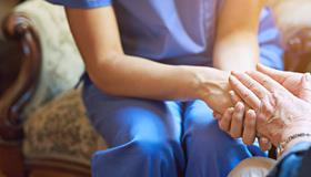 Two women holding hands