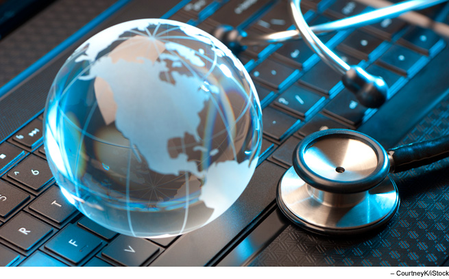 Stethoscope and glass globe on keyboard