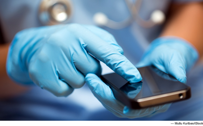 Photo of gloved hand using device