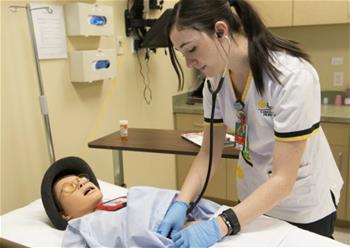 Nursing student with simulator