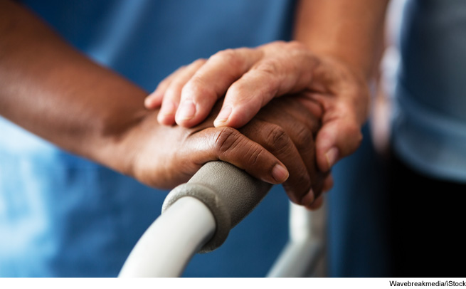 Hands resting on a walker