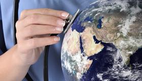 Stethoscope held against a globe