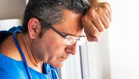 Man leaning against a window