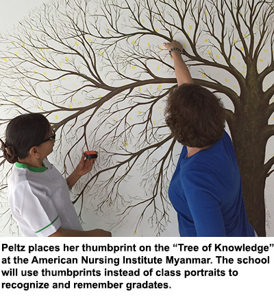 Caroline Peltz puts her thumbprint on the Tree of Knowledge.