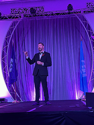 CEO Luke Davis on stage presenting Sigma Forward.