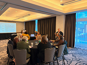 Members around a table at a pre-conference workshop.