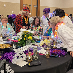 Trivia Night team deliberating over an answer.