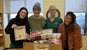 Jessica Norton and three others with their clothing drive box.